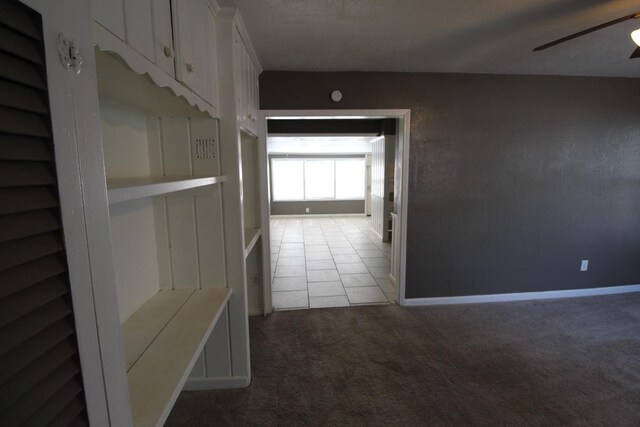 hall featuring carpet and a textured ceiling