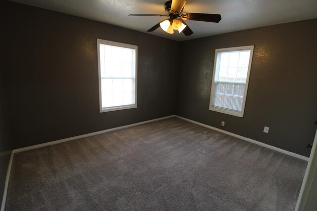 unfurnished room featuring ceiling fan and carpet