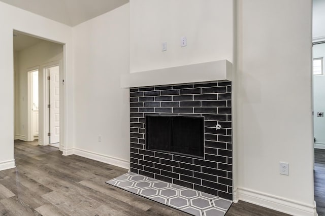 room details with hardwood / wood-style flooring and a tile fireplace