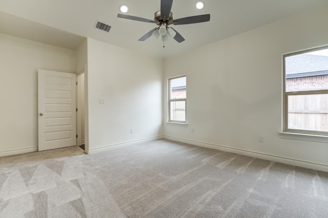 empty room with light carpet and ceiling fan