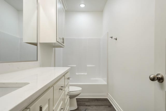 full bathroom featuring vanity, shower / bathing tub combination, wood-type flooring, and toilet