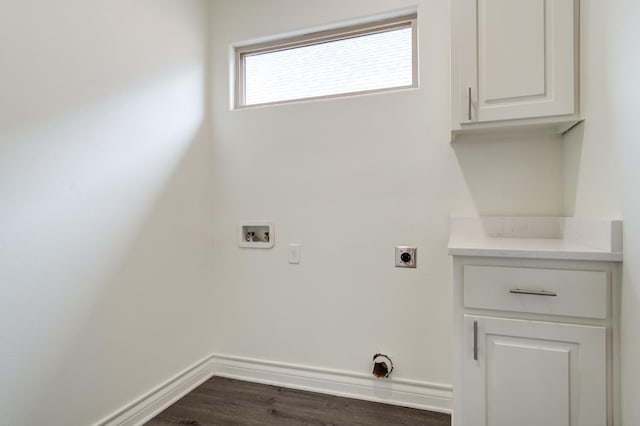 clothes washing area featuring dark hardwood / wood-style flooring, cabinets, hookup for a washing machine, and hookup for an electric dryer