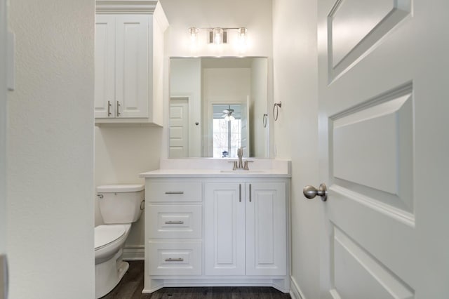 bathroom with vanity, wood-type flooring, and toilet