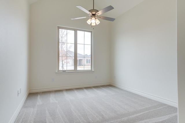 unfurnished room featuring vaulted ceiling, light carpet, and ceiling fan