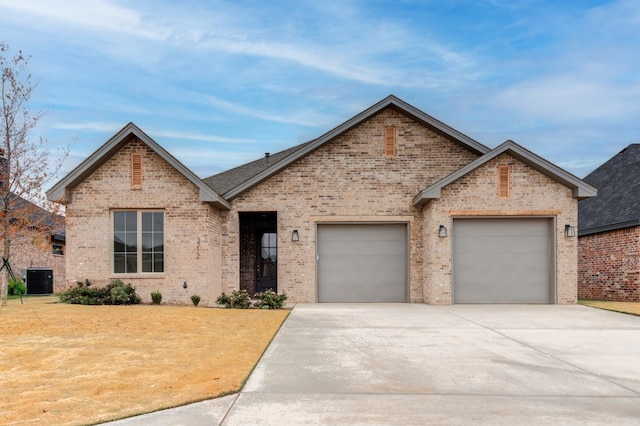 view of front of house featuring a garage and central AC unit