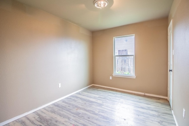 empty room with light hardwood / wood-style flooring