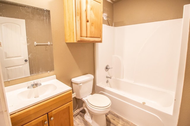 full bathroom with shower / washtub combination, toilet, wood-type flooring, and vanity