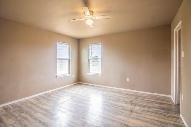 spare room with light hardwood / wood-style flooring and ceiling fan