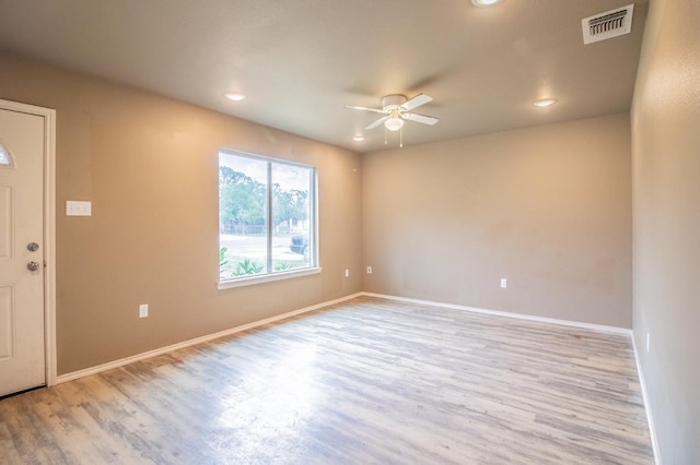 empty room with ceiling fan and light wood-type flooring