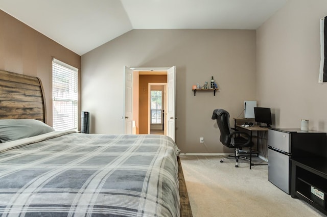 carpeted bedroom with lofted ceiling