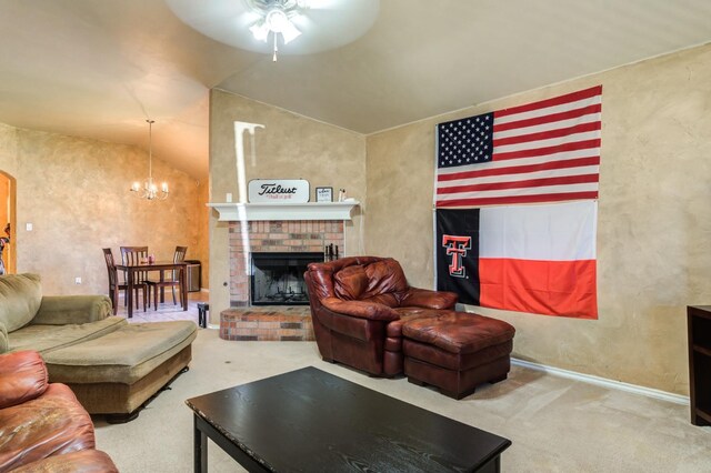 living room featuring lofted ceiling, a fireplace, ceiling fan with notable chandelier, and carpet