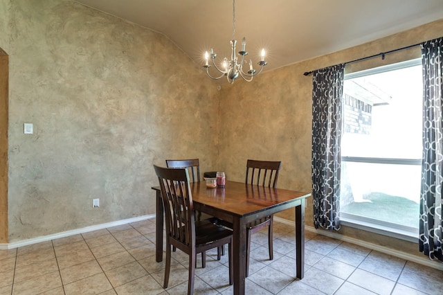 tiled dining area featuring an inviting chandelier and a healthy amount of sunlight