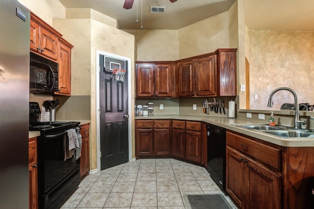 kitchen featuring sink, light tile patterned floors, black appliances, and ceiling fan