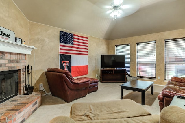 carpeted living room with ceiling fan, lofted ceiling, and a brick fireplace