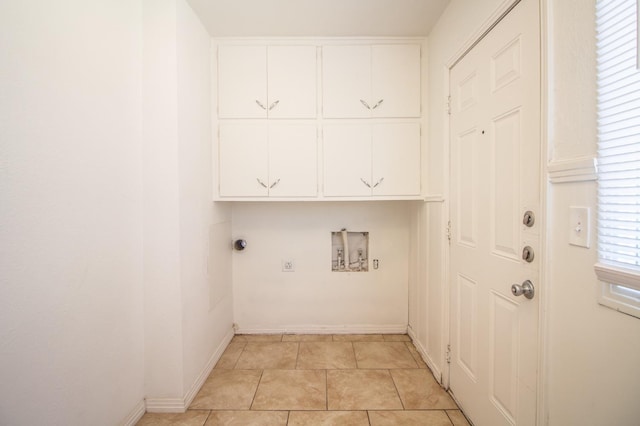 washroom featuring washer hookup, cabinets, hookup for an electric dryer, and light tile patterned flooring