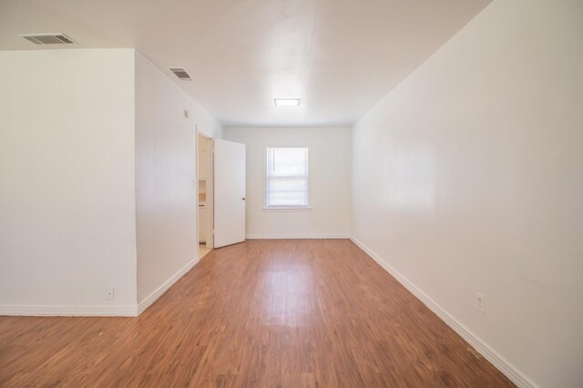 empty room featuring wood-type flooring