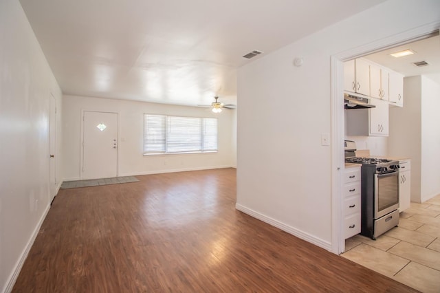 interior space with ceiling fan and light hardwood / wood-style flooring