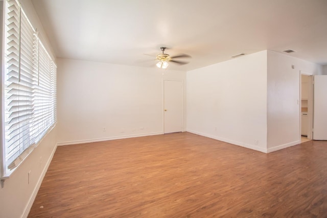 unfurnished room with wood-type flooring and ceiling fan