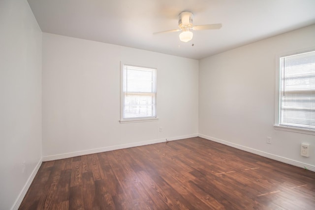 empty room featuring dark hardwood / wood-style flooring and ceiling fan