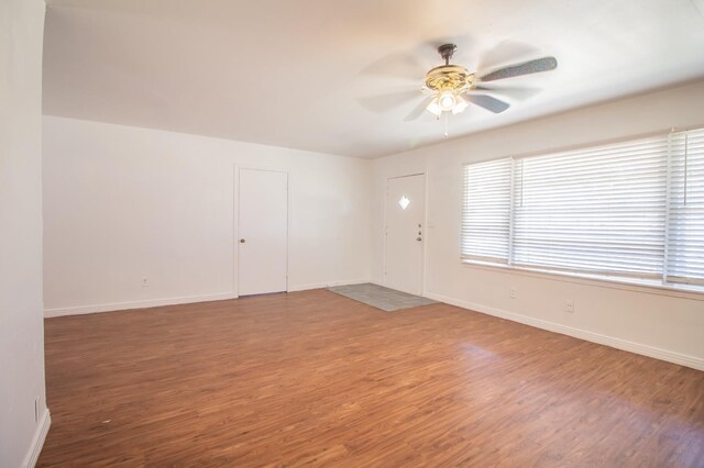 spare room featuring hardwood / wood-style floors and ceiling fan