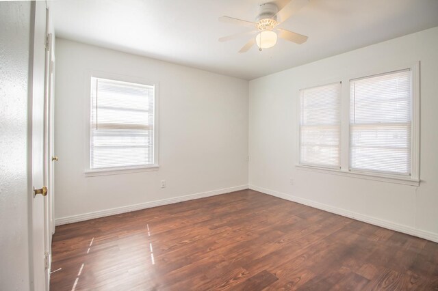 unfurnished room with ceiling fan and dark hardwood / wood-style flooring