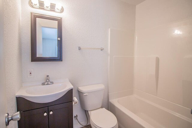 full bathroom with vanity, toilet, and washtub / shower combination