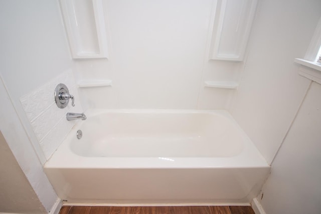 bathroom featuring a tub and hardwood / wood-style floors