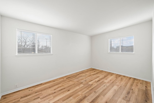 unfurnished room with light hardwood / wood-style flooring and a wealth of natural light