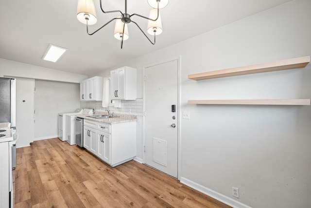 kitchen with white cabinetry, sink, light hardwood / wood-style floors, and decorative backsplash