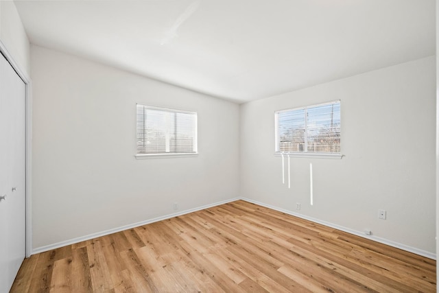 unfurnished room featuring plenty of natural light and light hardwood / wood-style floors