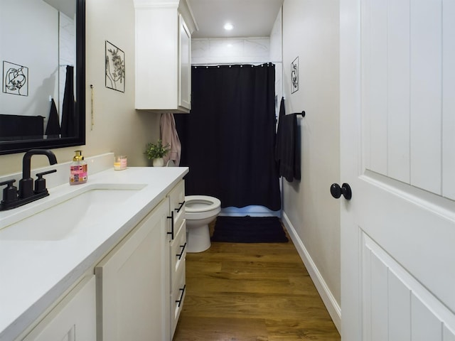 full bath with curtained shower, toilet, wood finished floors, vanity, and baseboards