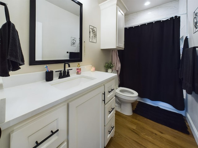 full bathroom with a shower with shower curtain, toilet, wood finished floors, vanity, and recessed lighting