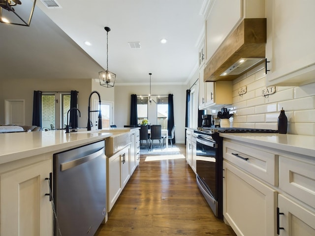 kitchen with tasteful backsplash, visible vents, custom range hood, stainless steel appliances, and light countertops