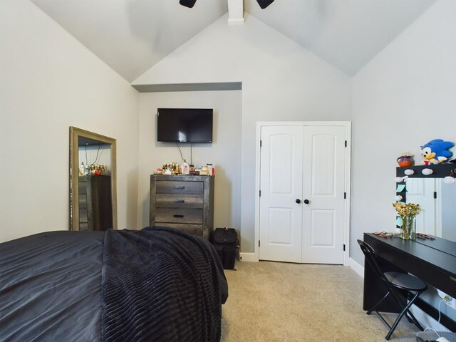 bedroom featuring vaulted ceiling with beams, a closet, light carpet, ceiling fan, and baseboards