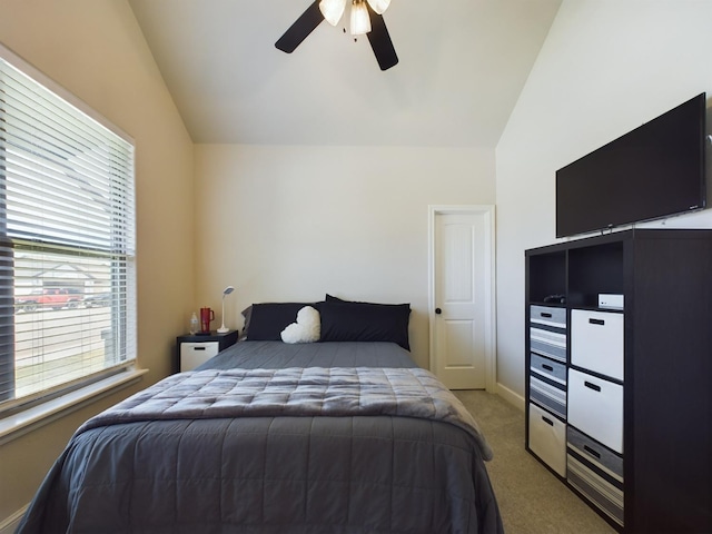 carpeted bedroom with lofted ceiling, baseboards, and a ceiling fan