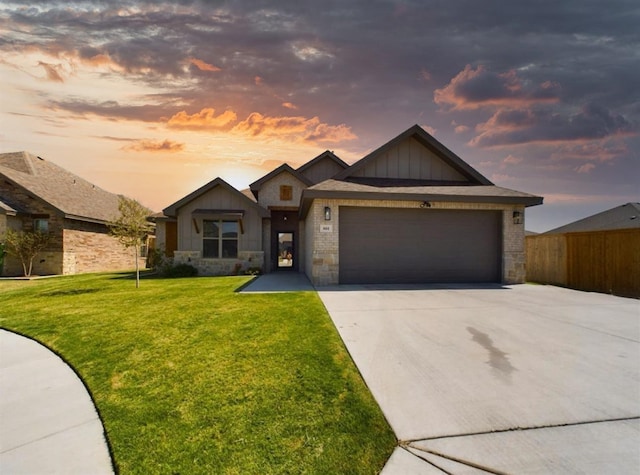 single story home featuring a garage, driveway, a lawn, stone siding, and board and batten siding