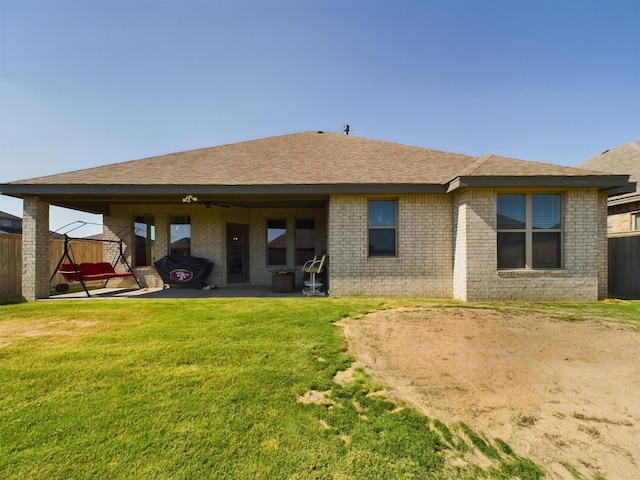 back of property with a patio area, fence, and a lawn