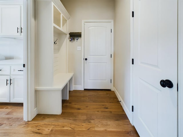 mudroom featuring light wood-type flooring and baseboards