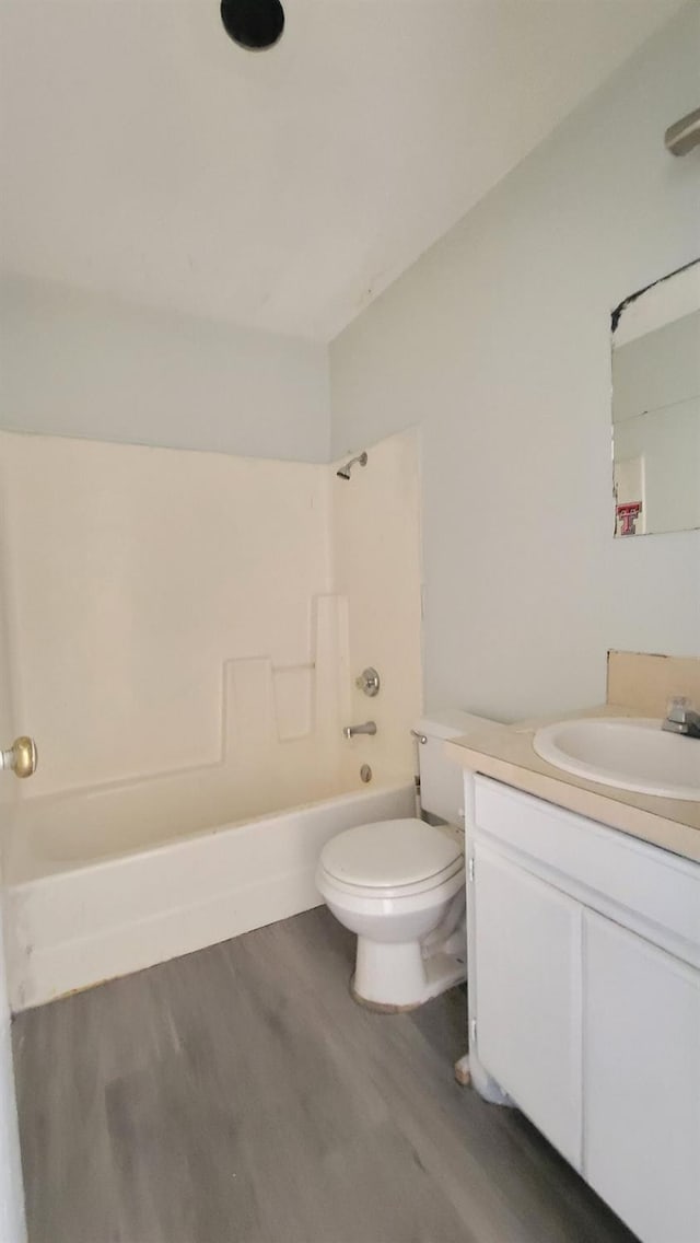 full bathroom featuring vanity, wood-type flooring, shower / washtub combination, and toilet