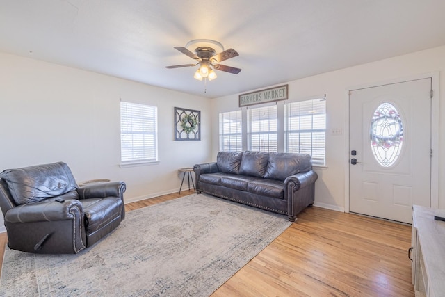 living room with ceiling fan, a healthy amount of sunlight, and light hardwood / wood-style floors