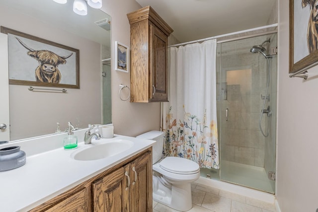 bathroom featuring vanity, tile patterned floors, toilet, and walk in shower