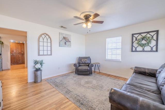 living room with ceiling fan and light hardwood / wood-style floors