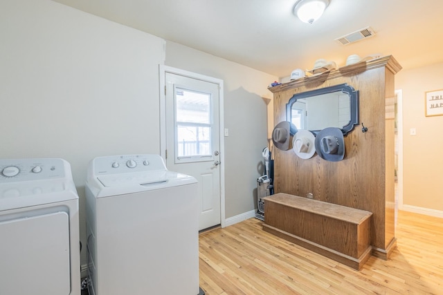 washroom featuring separate washer and dryer and light hardwood / wood-style floors