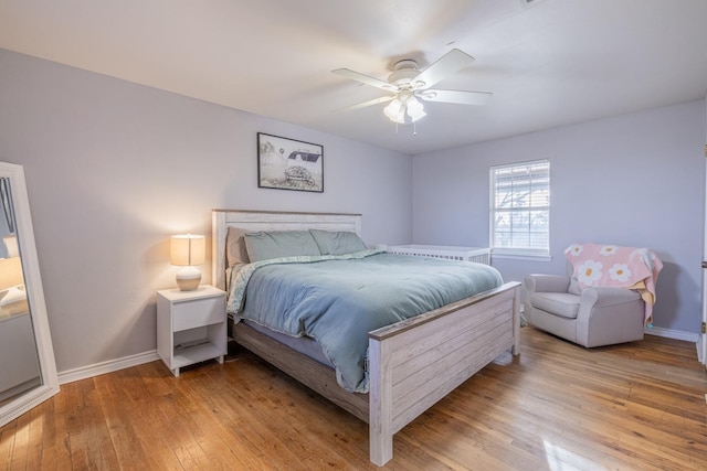 bedroom with light hardwood / wood-style flooring and ceiling fan