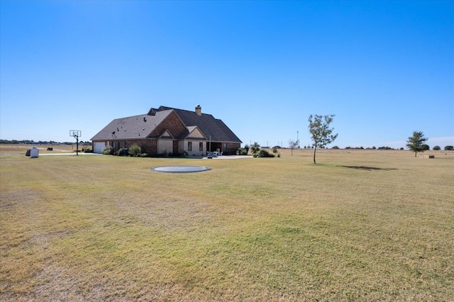 view of yard with a rural view