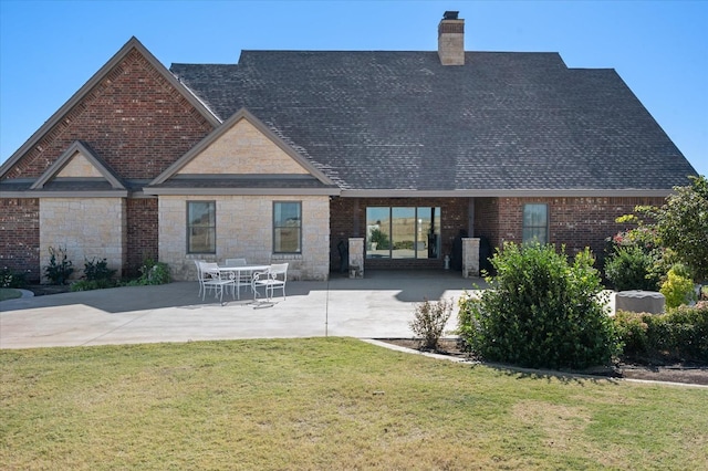 back of house featuring a yard and a patio