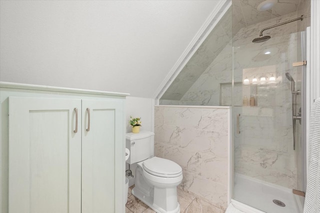 bathroom featuring lofted ceiling, a shower with door, tile walls, and toilet