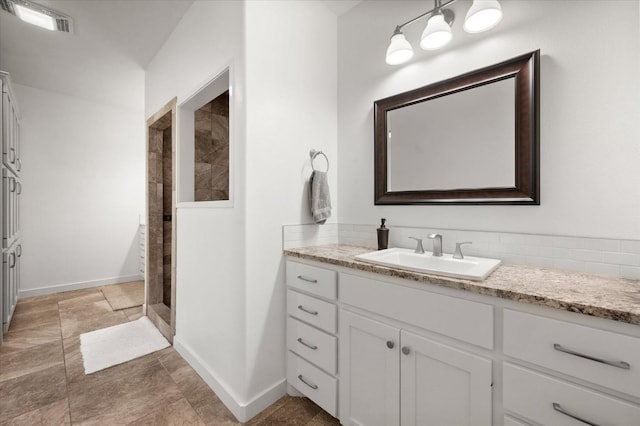 bathroom featuring walk in shower and vanity