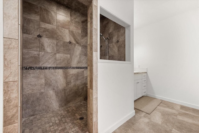 bathroom featuring vanity and tiled shower