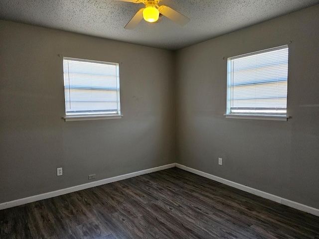 empty room with ceiling fan, a textured ceiling, and dark hardwood / wood-style flooring